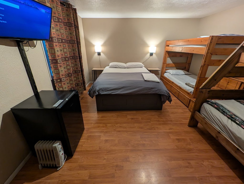 Room 1: Queen Room + 2 bunks along wall. 5 beds total